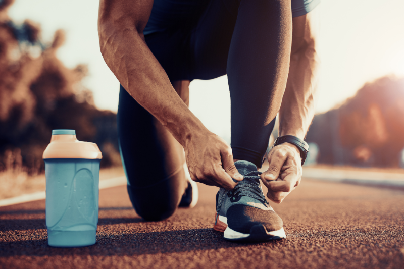 Man Tying Shoelaces of Running Shoes