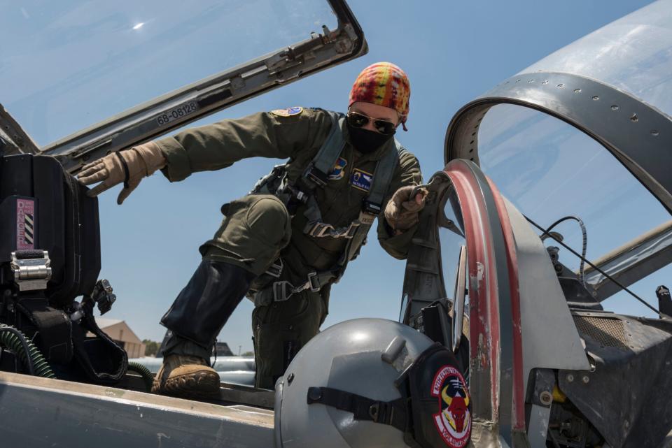 Capt. Natalie Rambish, 47th Operations Support Squadron aircrew and flight equipment commander and instructor pilot, climbs into her seat in a T-38C Talon as she prepares to fly with a student pilot at Laughlin Air Force Base, Texas. <em>U.S. Air Force photo by Senior Airman Anne McCready</em><br>