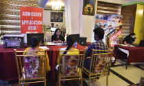 Indian students make enquiries at a Canadian education fair in in Amritsar, India, July 8, 2022. Many Indians are opting to go abroad for "better prospects" as raging unemployment is worsening insecurity and inequality between the rich and poor in Asia's third largest economy. (AP Photo/Prabhjot Gill)