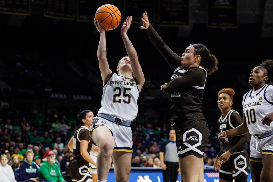 Notre Dame guard Sarah Cernugel (25) goes up for a shot as Western Michigan guard Denali Craig-Edwards (1) defends during the Western Michigan-Notre Dame NCAA Women’s basketball game on Thursday, December 21, 2023, at Purcell Pavilion in South Bend, Indiana.