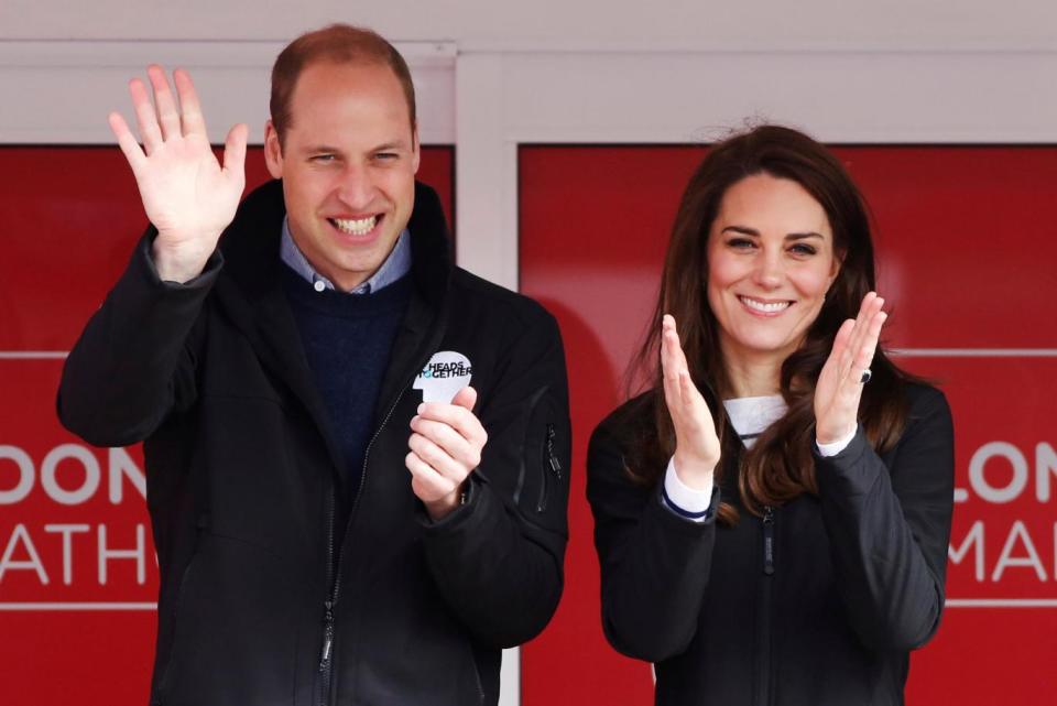 Supportive couple: Kate and William cheer on runners (REUTERS/Luke MacGregor)