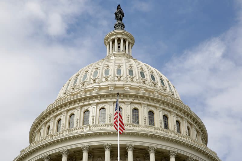 FILE PHOTO: The U.S. flag flies in front of the Capitol Dome at the U.S. Capitol in Washington