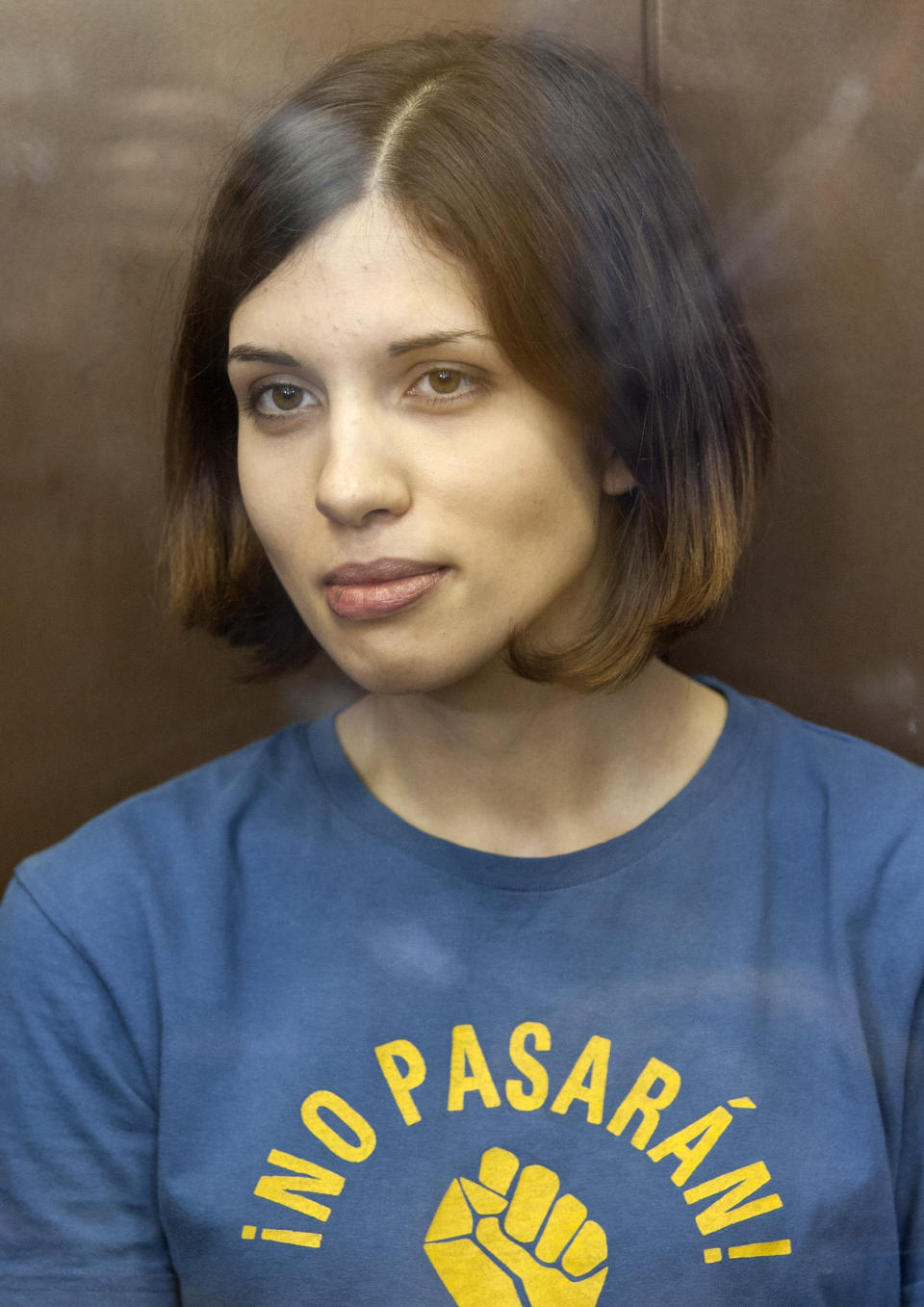 In this Aug. 17, 2012 file photo, feminist punk group Pussy Riot member Nadezhda Tolokonnikova sits in a glass enclosure at a court in Moscow, Russia. (AP Photo/Misha Japaridze, File)