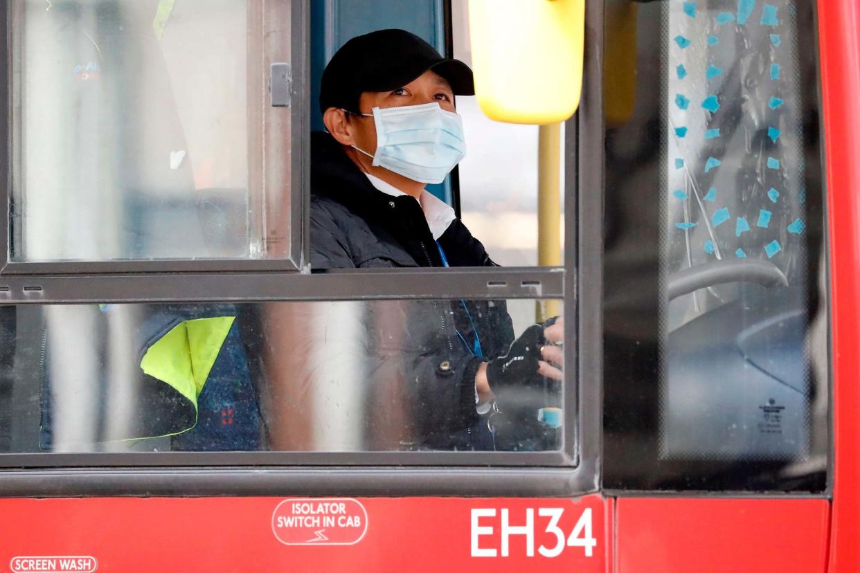 A Transport for London bus driver wearing a face mask: AFP via Getty Images