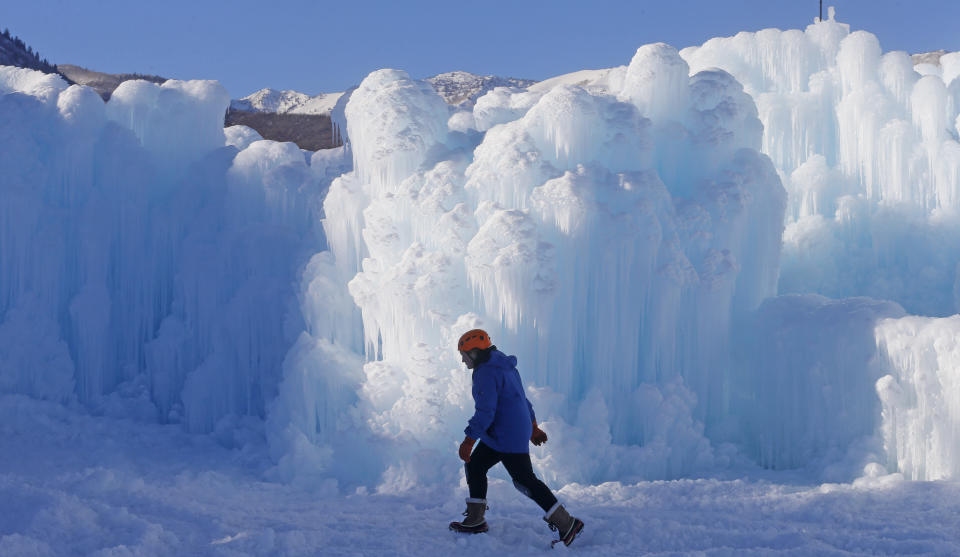 Midway Ice Castles take shape as artisans construct popular winter attraction Wednesday, Jan. 2, 2019, in Midway, Utah. A winter storm has covered cactus with snow in parts of the American Southwest as temperatures in the desert fall below those of Anchorage, Alaska. (AP Photo/Rick Bowmer)