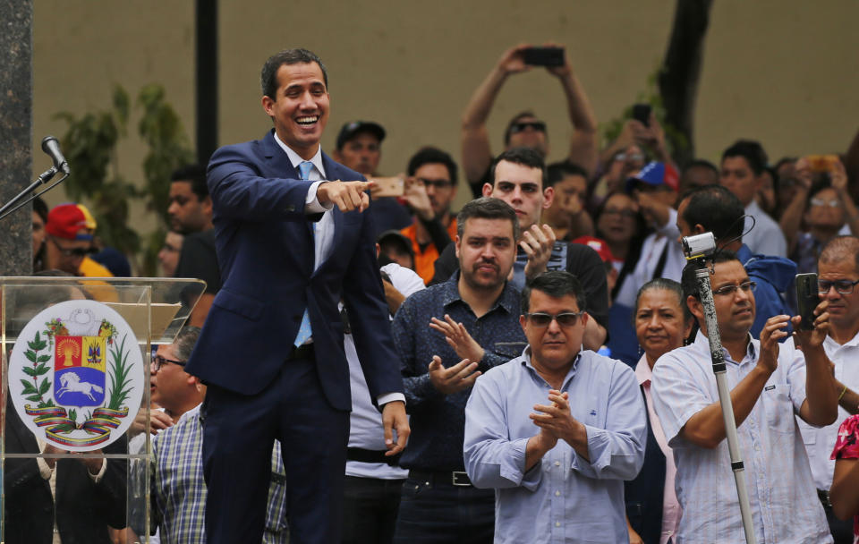 Juan Guaido, opposition leader and self-proclaimed interim president of Venezuela, points to supporters as he arrives to Plaza Bolivar for an outdoor, town hall-style meeting in the Chacao area of Caracas, Venezuela, Friday, April 19, 2019. The opposition held the forum to announce a new strategy against the government of President Nicolas Maduro. (AP Photo/Fernando Llano)