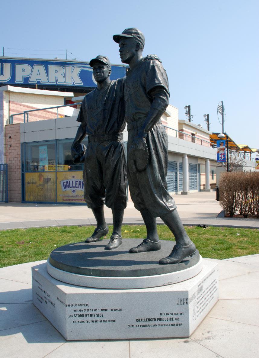 This undated image provided by the Brooklyn Cyclones shows a statue of Pee Wee Reese and Jackie Robinson at MCU Park in the Coney Island section of the Brooklyn borough of New York, where the minor league Cyclones team plays. A new film, “42,” tells the inspiring story of how Robinson integrated Major League Baseball when he played for the Brooklyn Dodgers. The pedestal of the statue states that Reese, captain of the Dodgers, “stood by Jackie Robinson against prejudiced fans and fellow players” by walking over to Robinson, standing next to him and “silencing the taunts of the crowd” during a game in Cincinnati. (AP Photo/Brooklyn Cyclones)