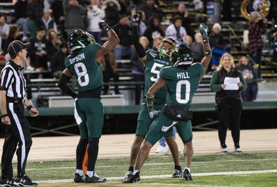 Sacramento State Hornets teammates wide receiver Jared Gipson (8) wide receiver Devin Gandy (5) and wide receiver Carlos Hill (0)] celebrate Gandy’s touchdown against Idaho State in the second half at Hornet Stadium on Saturday.