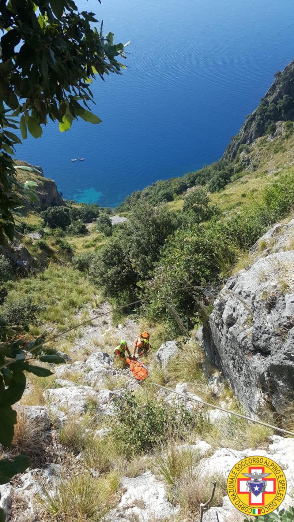 Members of the Italian mountain rescue team search for a French hiker in the Cilento region, Southern Italy, Monday, Aug. 19, 2019. Italian mountain rescue squads have recovered the body of a French hiker who fell into a ravine and broke his leg. Nine days of search ended Sunday when alpine rescue spotted Simon Gautier’s backpack and then his body in a ravine in the Cilento region of Southern Italy. Crews were able to recover the body Monday. (Corpo Nazionale Soccorso Alpino e Speleologico via AP)