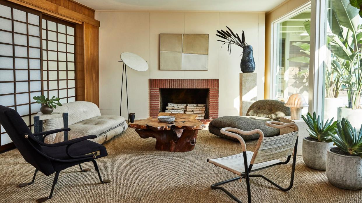  Living room with mid century style furniture and warm natural tones. 