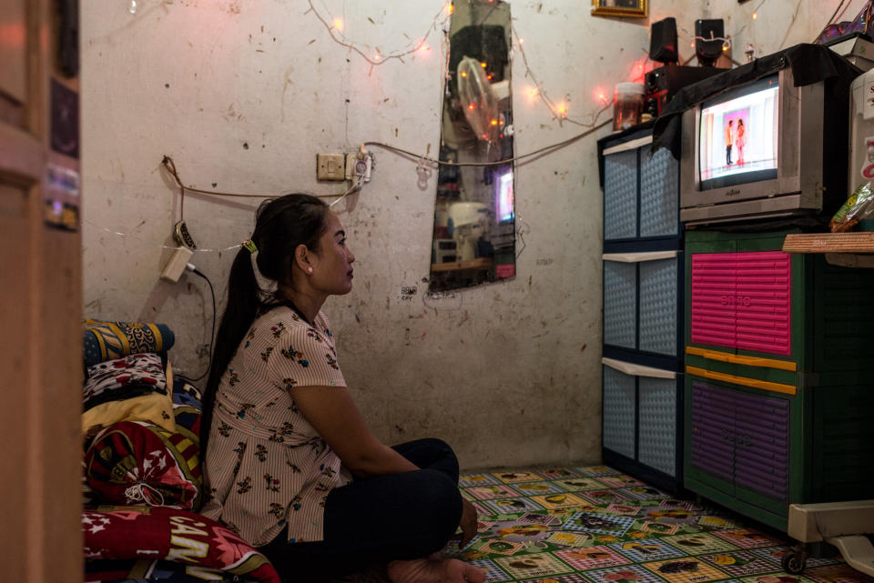 After work, Istiy&nbsp;watches TV in her tiny rental home. (Photo: Elisabetta Zavoli for HuffPost)