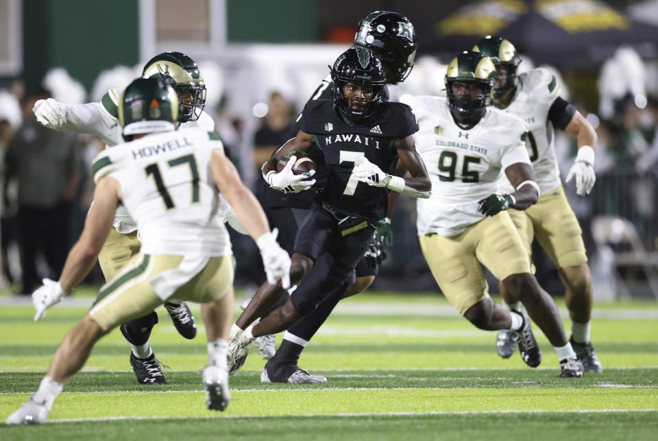 Hawaii wide receiver Steven McBride (7) runs through the Colorado State defense during the first half of an NCAA college football game Saturday, Nov. 25, 2023, in Honolulu. (AP Photo/Marco Garcia)