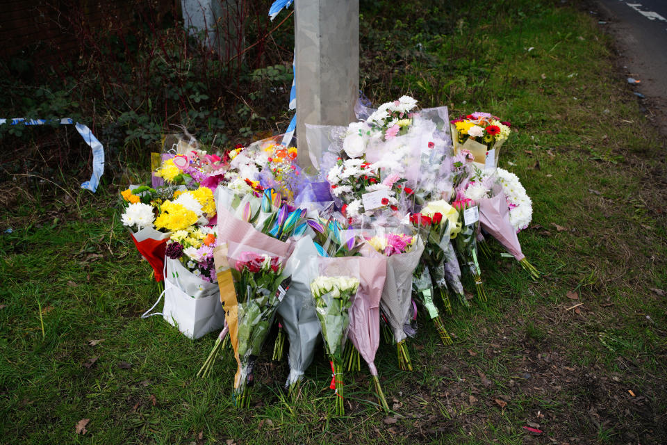 Tributes left near the scene in the St Mellons area of Cardiff where three people who disappeared on a night out died in a road traffic accident. (PA via Getty)