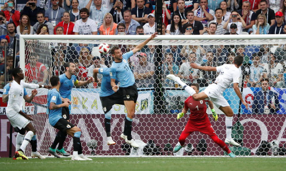 <p>France’s Raphael Varane scores their first goal. </p>