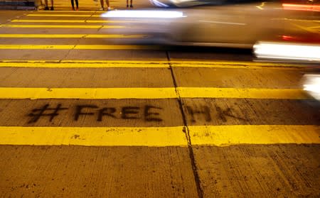 FILE PHOTO: A graffiti is seen at a pedestrian crossing near the Police station at Mong Kok district in Hong Kong