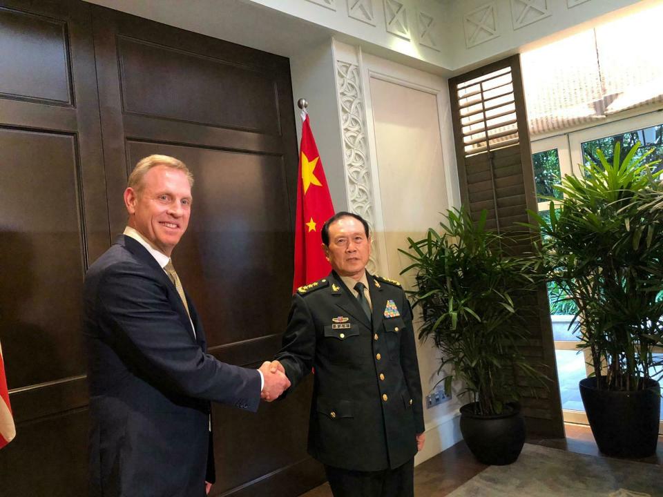 Acting U.S. Secretary of Defense Patrick Shanahan, left, shakes hands with Chinese Minister of National Defense Wei Fenghe during a meeting on the sidelines of the 18th International Institute for Strategic Studies (IISS) Shangri-la Dialogue, an annual defense and security forum in Asia, in Singapore, Friday, May 31, 2019. (AP Photo/Lolita Baldor)