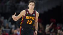 Atlanta Hawks guard Bogdan Bogdanovic reacts after making a three pointer during the first half of an NBA basketball game against the Oklahoma City, Thunder Monday, Dec. 5, 2022, in Atlanta. (AP Photo/Hakim Wright Sr.)