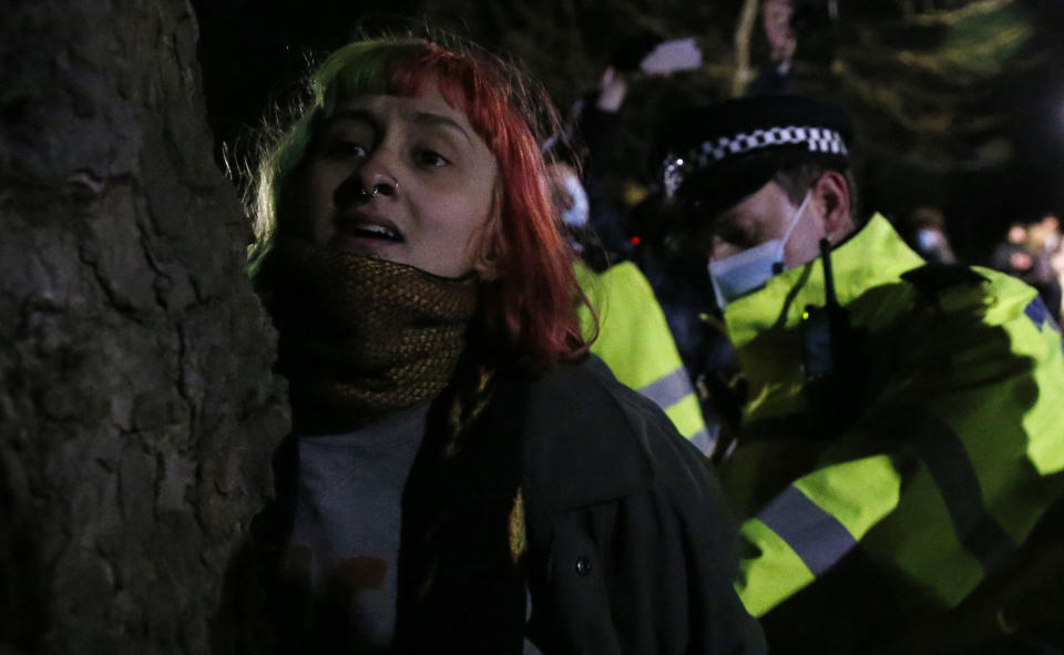 LONDON, ENGLAND - MARCH 13: A woman is arrested during a vigil for Sarah Everard on Clapham Common on March 13, 2021 in London, United Kingdom. Vigils are being held across the United Kingdom in memory of Sarah Everard. Yesterday, the Police confirmed that the remains of Ms Everard were found in a woodland area in Ashford, a week after she went missing as she walked home from visiting a friend in Clapham. Metropolitan Police Officer Wayne Couzens has been charged with her kidnap and murder. (Photo by Hollie Adams/Getty Images)