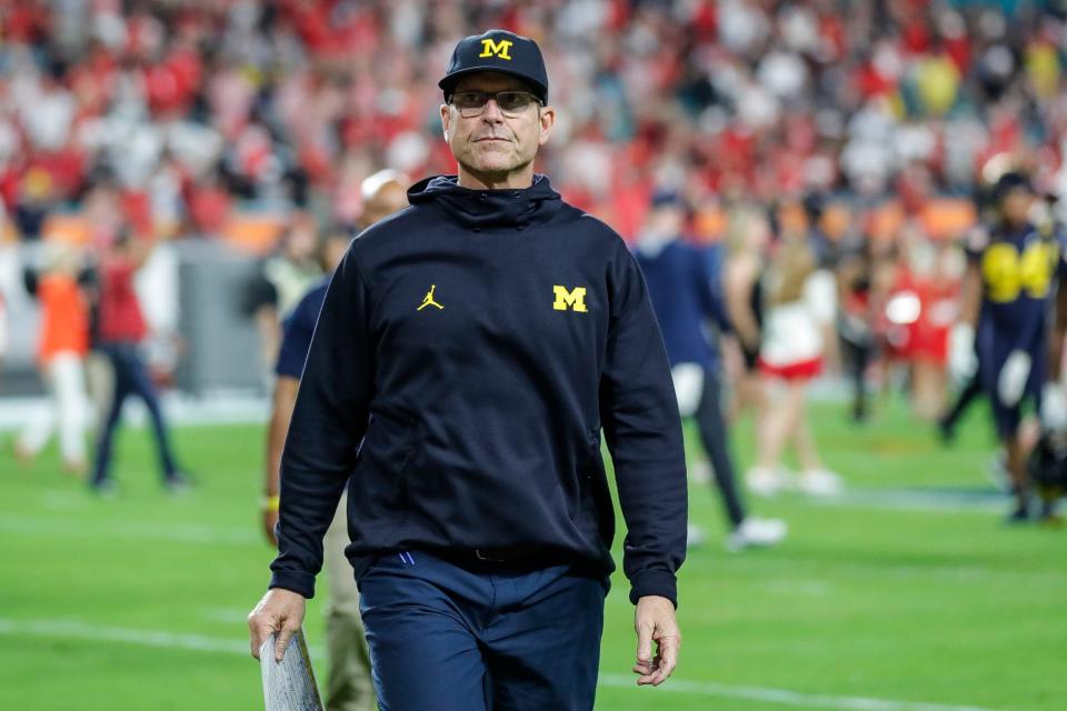 Michigan head coach Jim Harbaugh walks off the field after the Wolverines lost, 34-11, to Georgia at the Orange Bowl at Hard Rock Stadium in Miami Gardens, Florida, on Friday, Dec. 31, 2021.