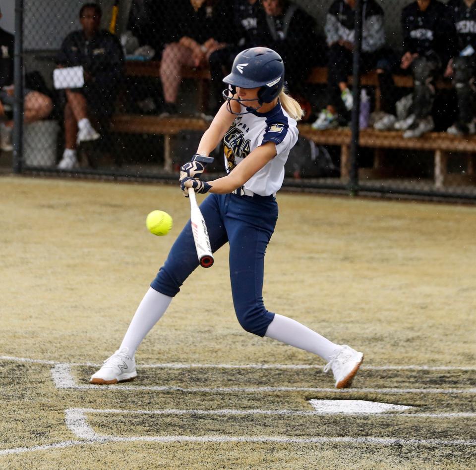 New Prairie junior Ella Chelminiak rips an RBI double in the fourth inning of a softball game against Penn Monday, May 13, 2024, at Penn High School in Mishawaka.