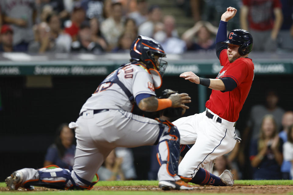 Cleveland Guardians' Owen Miller scores past Houston Astros catcher Martin Maldonado on a single by Luke Maile during the seventh inning of a baseball game Friday, Aug. 5, 2022, in Cleveland. (AP Photo/Ron Schwane)