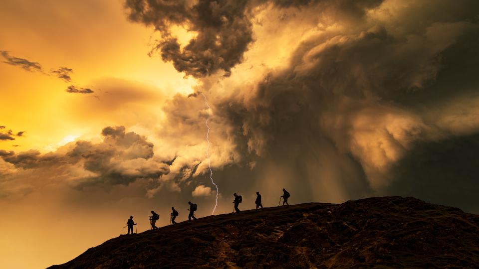 Hikers on the storm at sunset, Catbells Mountain, Lake District. UK