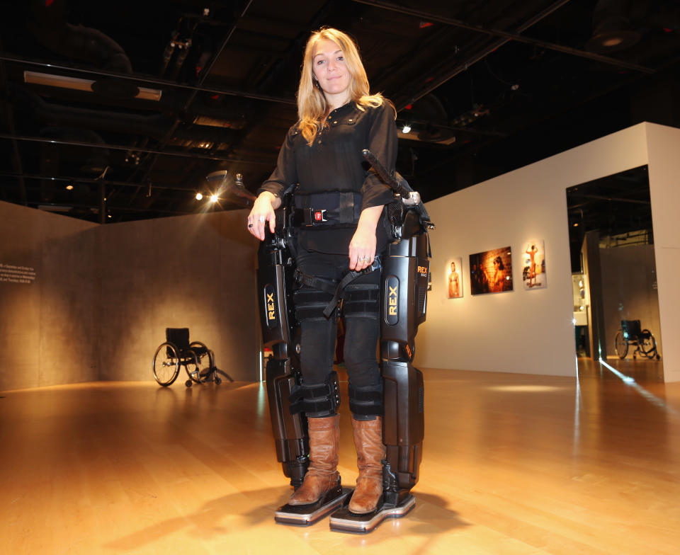 Sophie Morgan walks with the aid of 'Rex', a Robotic Exoskeleton at the Welcome Trust on September 19, 2012 in London, England. The system allows wheelchair users including fully paralysed people, to stand upright and walk independently. Sophie was paralysed from the breast bone down in 2003 following a car accident.  (Photo by Dan Kitwood/Getty Images)