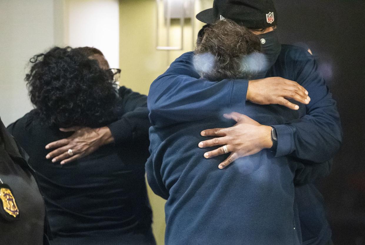 People hug after learning that their loved one is safe after a shooting inside a FedEx building Friday, April 16. 