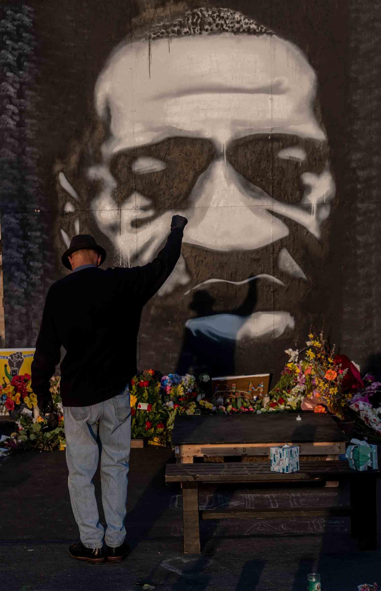 A man pays tribute to George Floyd at the memorial outside Cup Foods in Minneapolis