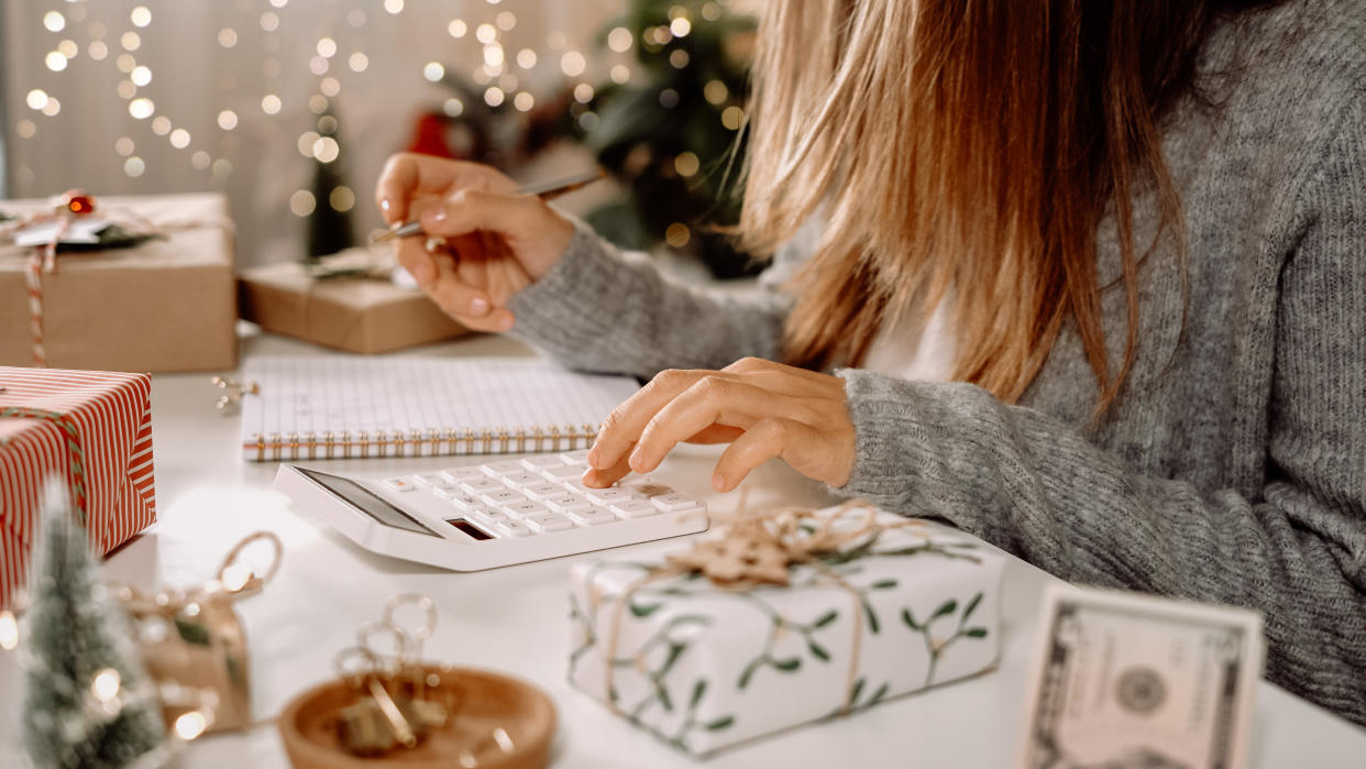  Woman budgeting holiday personal finances. 