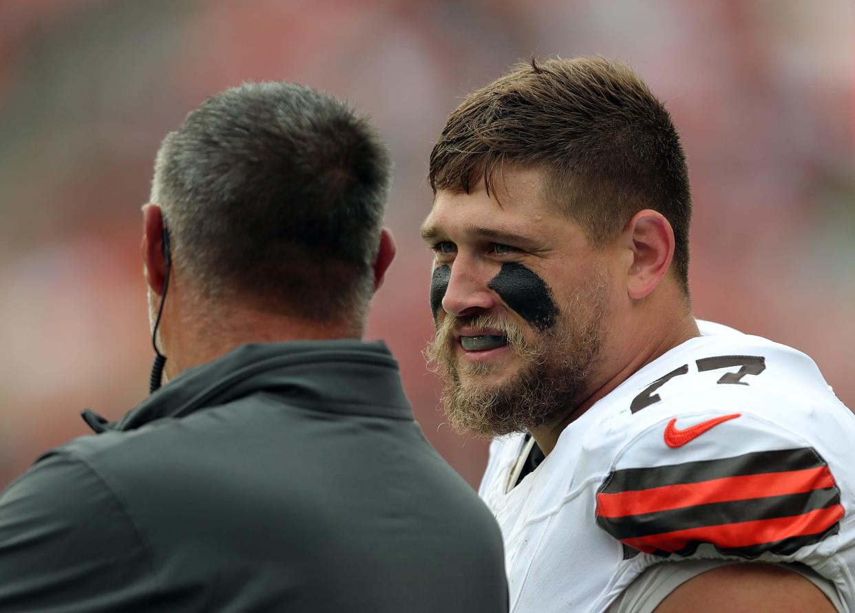 Cleveland Browns guard Wyatt Teller (77) chats with senior consultant Mike Vrabel on the sideline during a preseason game Aug. 10 in Cleveland.