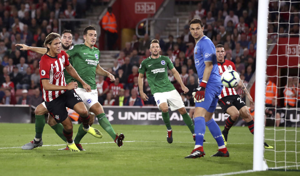 Brighton & Hove Albion's Shane Duffy, 2nd left, scores his side's first goal of the game against Southampton during their English Premier League soccer match at St Mary's in Southampton, England, Monday Sept. 17, 2018. (John Walton/PA via AP)