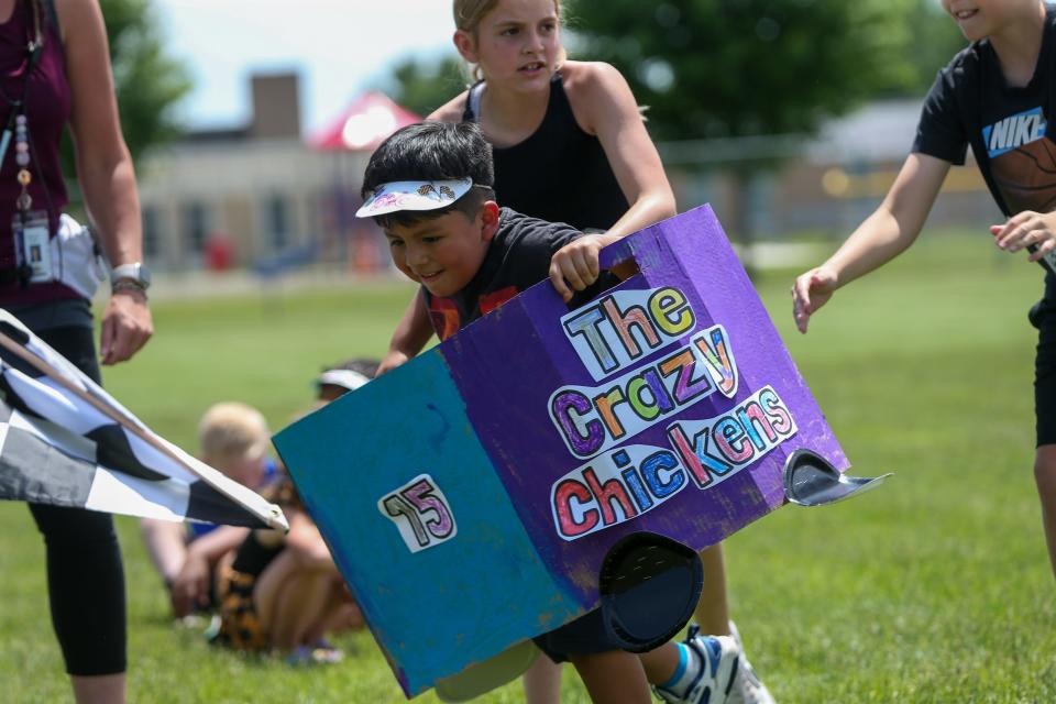 A Mayflower Mill Elementary School kindergartener runs around Mayflower Mill Elementary School's Kindy 500 course set up in McCutcheon High School’s soccer field, on Monday, May 22, 2023, in Lafayette, Indiana.