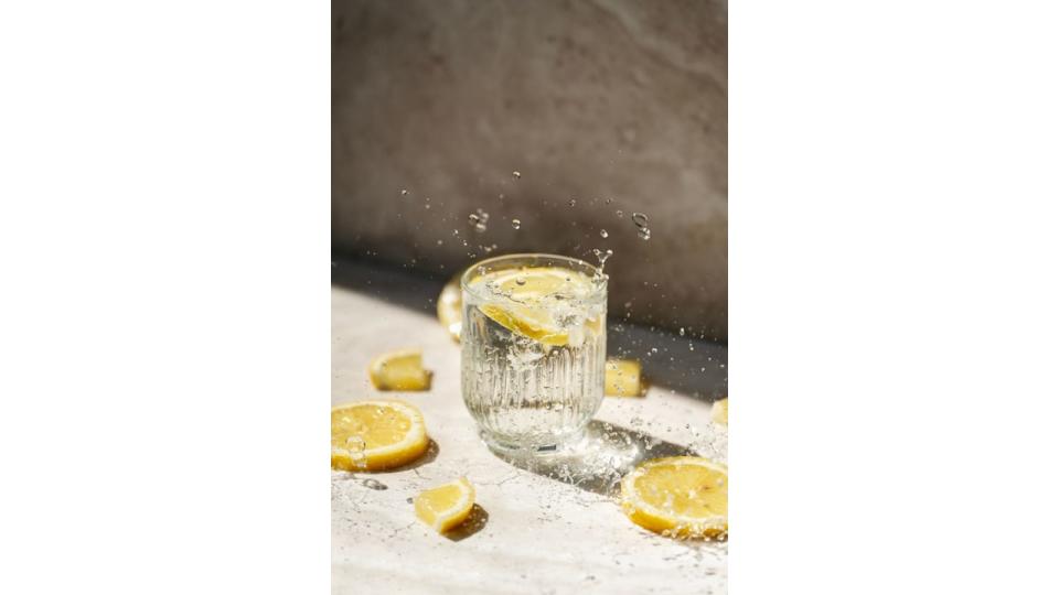 Glass of water with lemon and splash