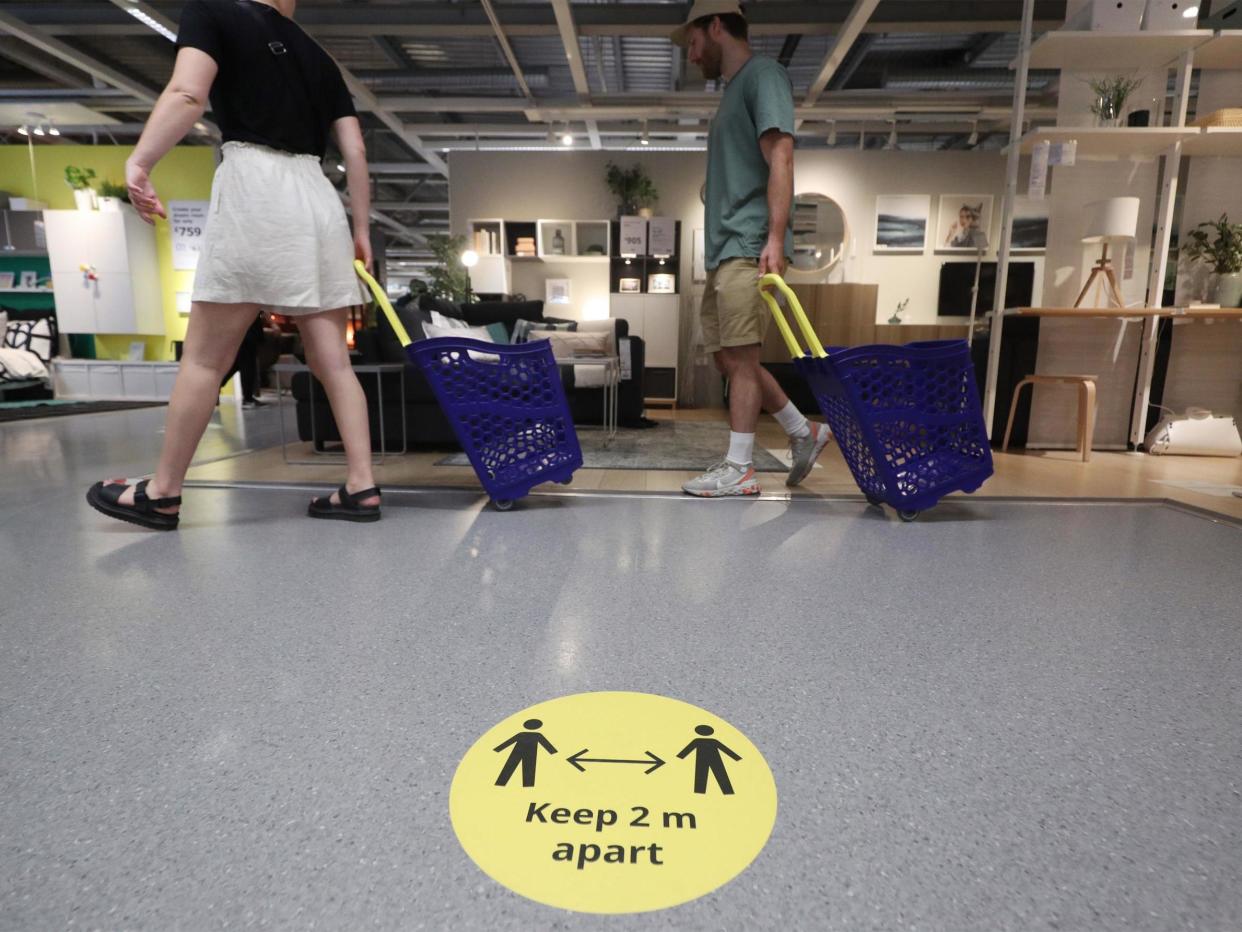 Customers observe social distancing inside the IKEA Tottenham store in Edmonton, north London, as it reopens to the public: PA
