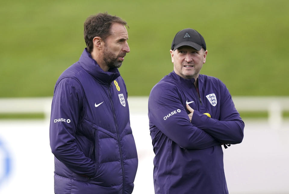England manager Gareth Southgate, left, with assistant Steve Holland leads training session ahead of Saturday's friendly soccer match against Brazil, at St. George's Park, Burton upon Trent, England, Friday March 22, 2024. (Mike Egerton/PA via AP)