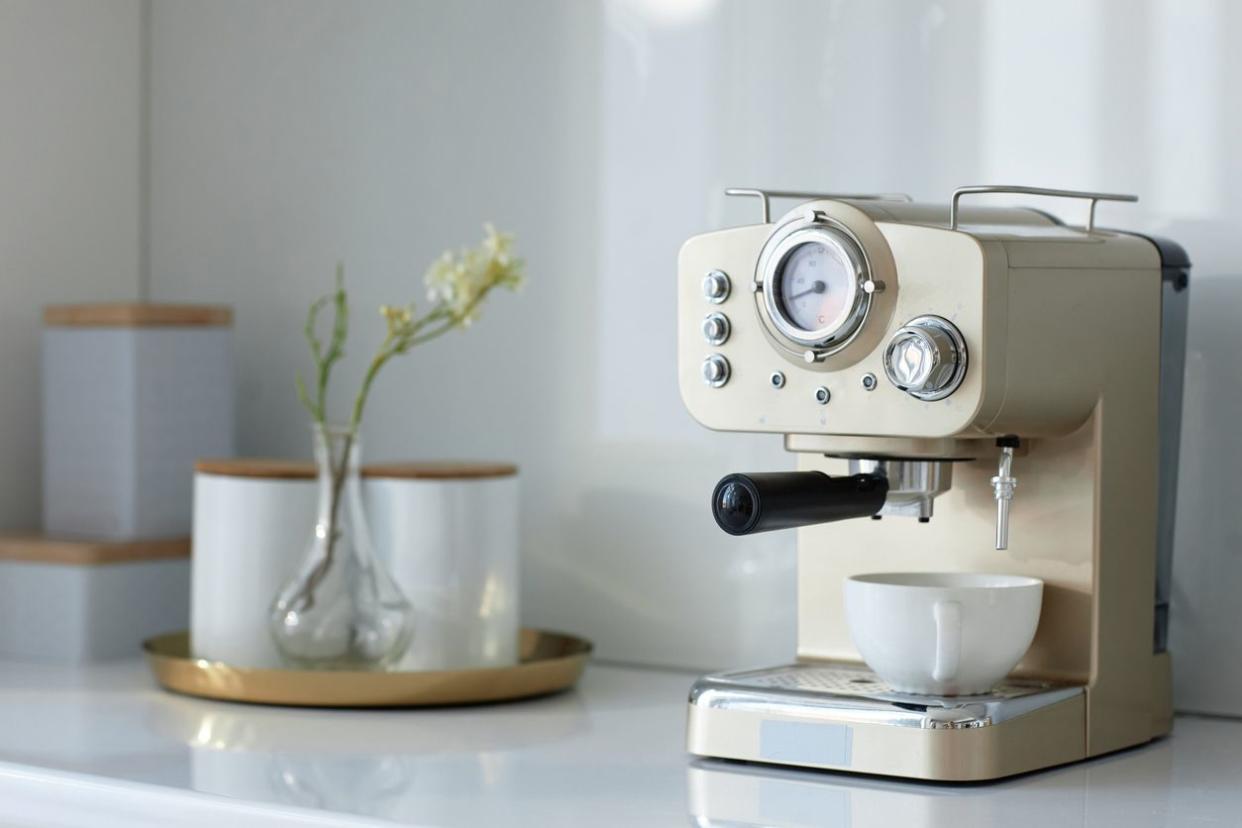 A nice espresso maker that's been set up on a kitchen countertop.