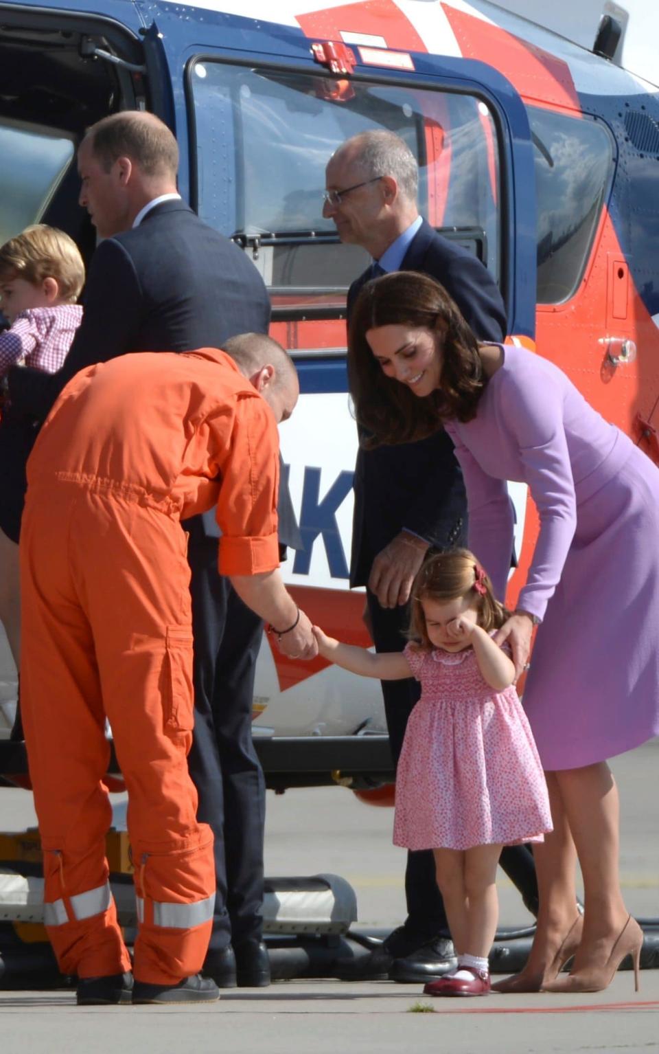 Princess Charlotte is comforted by the helicopter crew after she fell over - Credit: Christina Sabrowsky