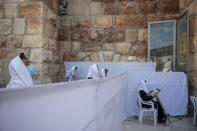 Ultra-Orthodox Jewish men pray in divided sections which allow a maximum of twenty worshipers in line with government measures to help stop the spread of the coronavirus, at the Western Wall, the holiest site where Jews can pray, in Jerusalem's Old City, Thursday, July 16, 2020. (AP Photo/Oded Balilty)