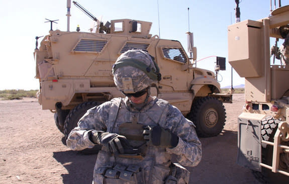 A Soldier demonstrates Nett Warrior, a Soldier-worn mission command system that could soon get wireless charging for its gadgets.