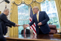 President Donald Trump receives a letter presented to him by Chinese Vice Premier Liu He, left, in the Oval Office of the White House in Washington, Friday, Oct. 11, 2019. (AP Photo/Andrew Harnik)