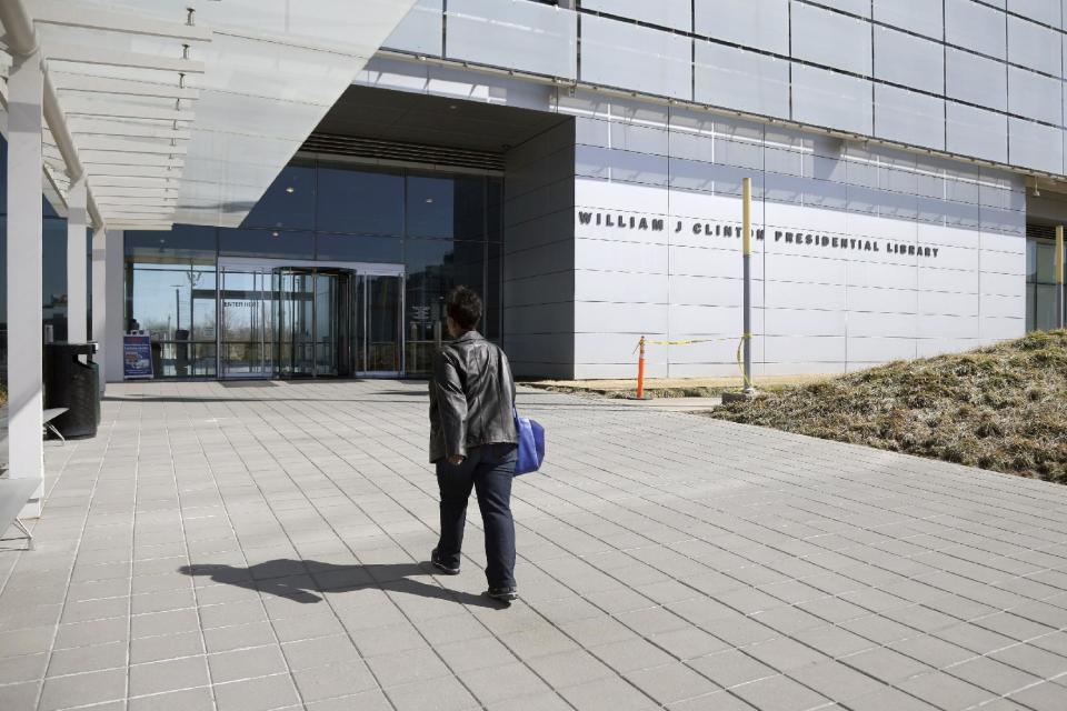 In this photo taken Thursday, March 13, 2014, a woman walks to the Clinton Presidential Library in Little Rock, Ark. The National Archives is scheduled to release thousands of pages of documents from Bill Clinton's administration Friday March 28, 2014. (AP Photo/Danny Johnston)
