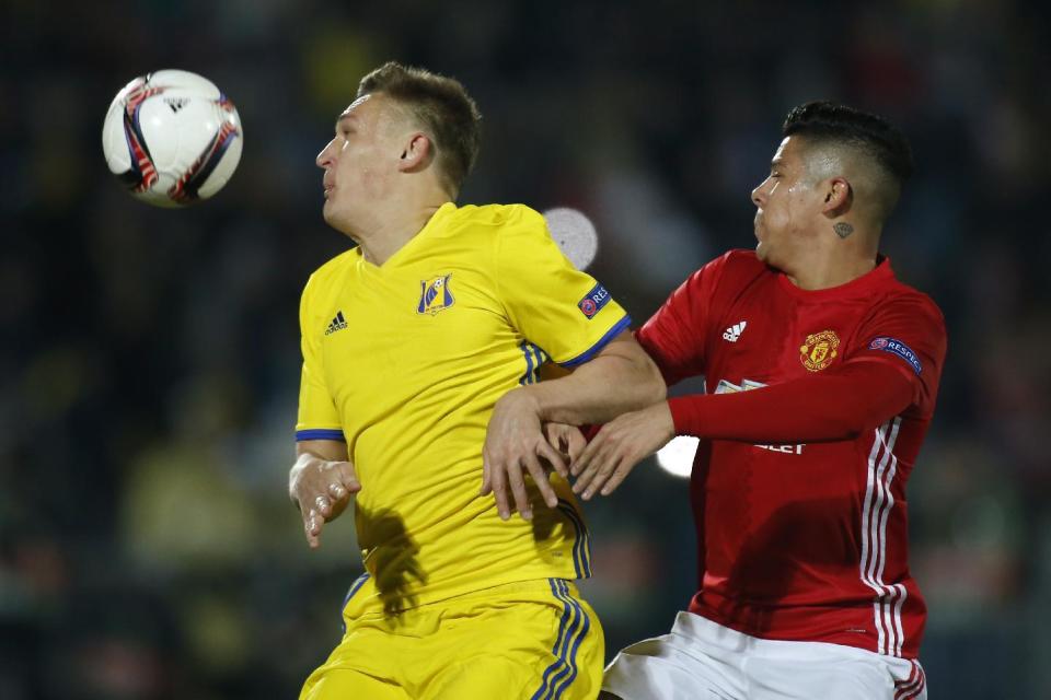 <p>Manchester United’s Marcos Rojo against Rostov goalscorer Aleksandr Bukharov</p>