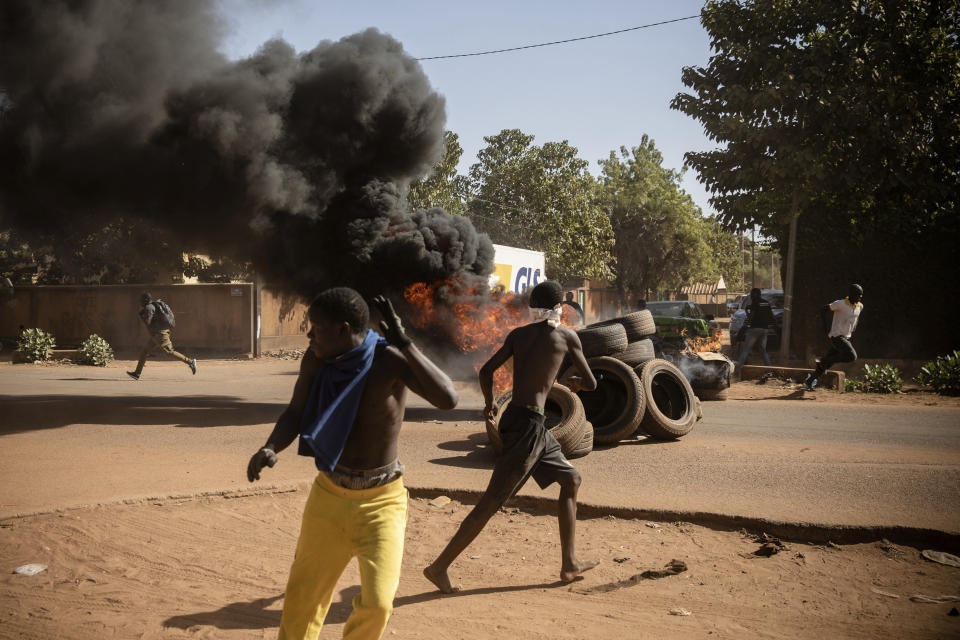 Protestors take to the streets of Burkina Faso's capital Ouagadougou Saturday Nov. 27, 2021, calling for President Roch Marc Christian Kabore to resign. The protest comes after the deadliest attack in years against the security forces in the Sahel's Soum province earlier this month, where more than 50 security forces were killed and after an attack in the Center North region where 19 people including nine members of the security forces were killed. (AP Photo/Sophie Garcia)