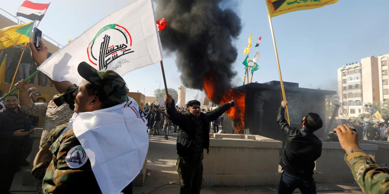 Protesters and militia fighters set on fire a security building of the U.S. Embassy, as people gather to condemn air strikes on bases belonging to Hashd al-Shaabi (paramilitary forces), in Baghdad, Iraq December 31, 2019.