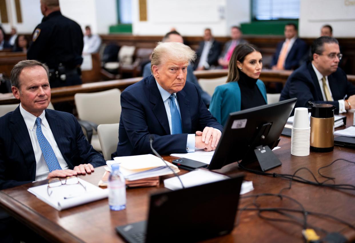 Former President Donald Trump sits with his legal team before the continuation of his civil fraud trial at New York Supreme Court on 18 October 2023 (AP)