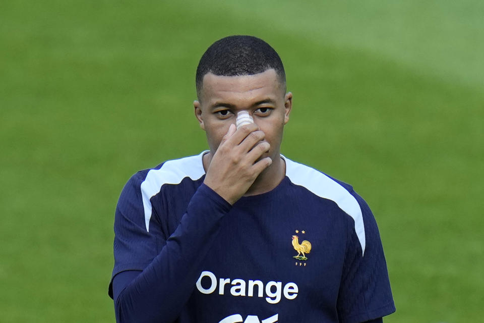 France's Kylian Mbappe gestures as he speaks with his head coach Didier Deschamps during a training session in Paderborn, Germany, Wednesday, June 19, 2024. France will play against Netherland during their Group D soccer match at the Euro 2024 soccer tournament on June 21. (AP Photo/Hassan Ammar)