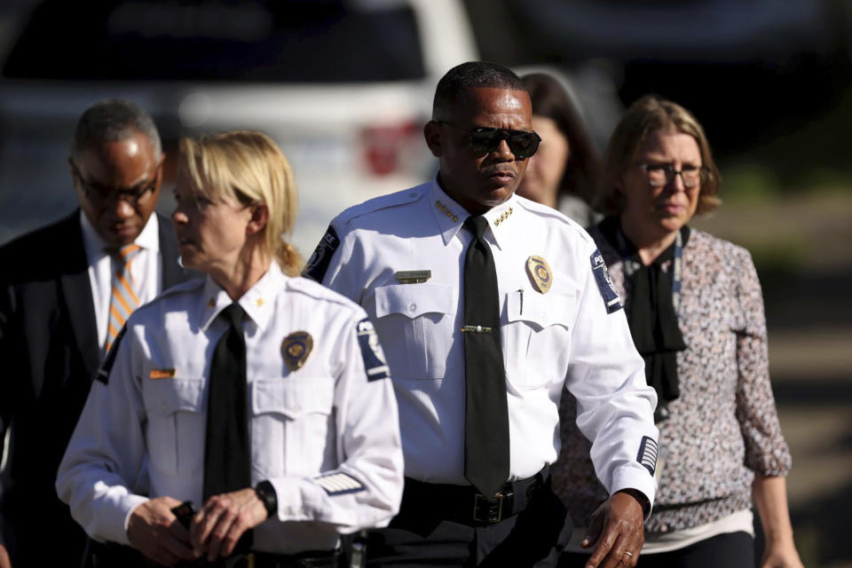 Charlotte Mecklenburg Police Chief Johnny Jennings, center, leaves the scene where multiple law enforcement officers were shot on Galway Drive in Charlotte, N.C. on Monday, April 29, 2024. Several officers on a U.S. Marshals Task Force serving a warrant for a felon wanted for possessing a firearm were killed and other officers were wounded in a shootout Monday in a North Carolina, home, police said. (Khadejeh Nikouyeh/The Charlotte Observer via AP)