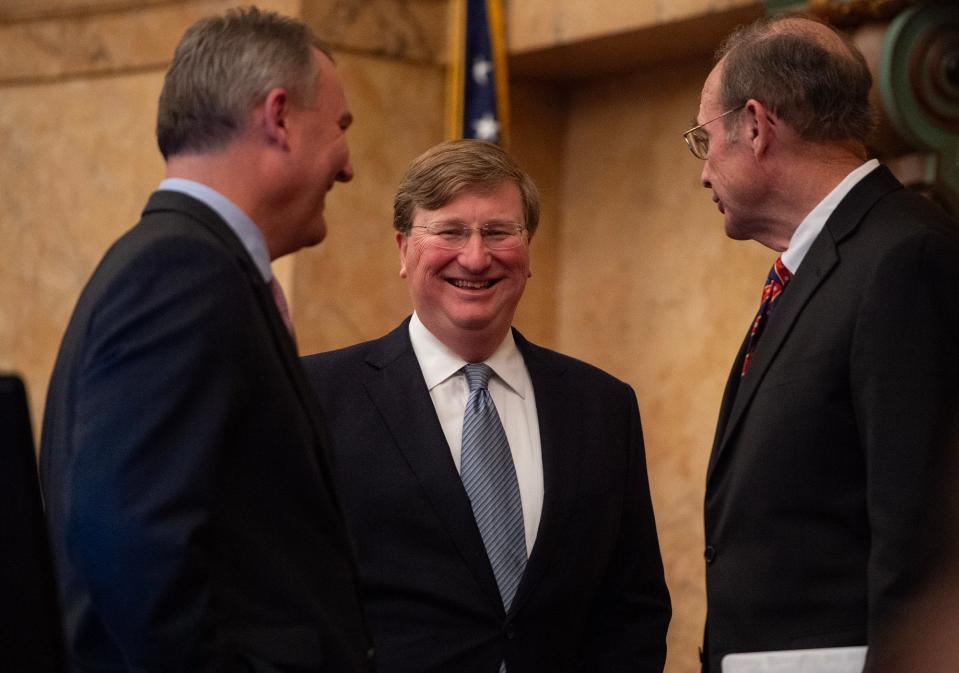 Gov. Tate Reeves speaks with House Speaker Jason White and Lt. Gov. Delbert Hosemann after he gave the Mississippi State of the State address at the Mississippi State Capitol in Jackson on Monday.