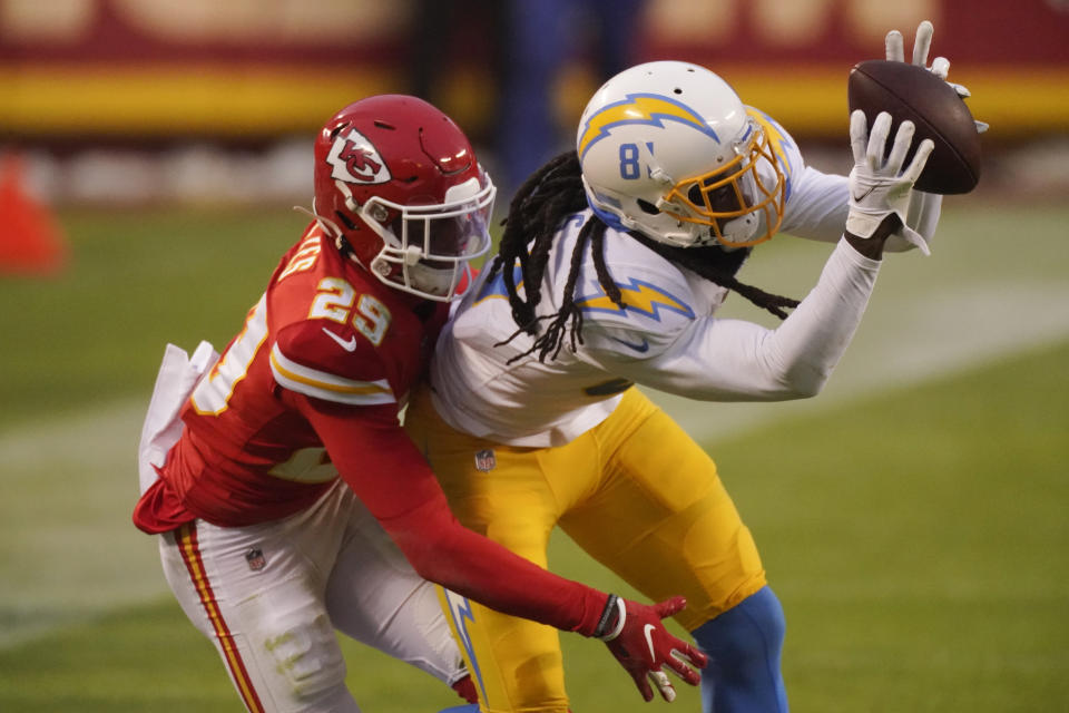 Los Angeles Chargers wide receiver Mike Williams catches a pass in front of Kansas City Chiefs cornerback Bopete Keyes, left, during the first half of an NFL football game, Sunday, Jan. 3, 2021, in Kansas City. (AP Photo/Charlie Riedel)